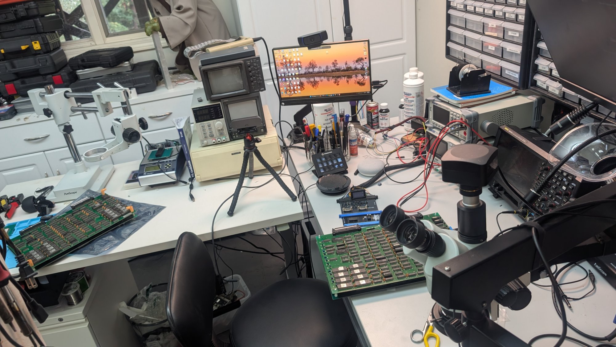 Professional arcade board repair workbench with oscilloscope, stereo microscope, and JAMMA boards at Woodside Arcade Repair
